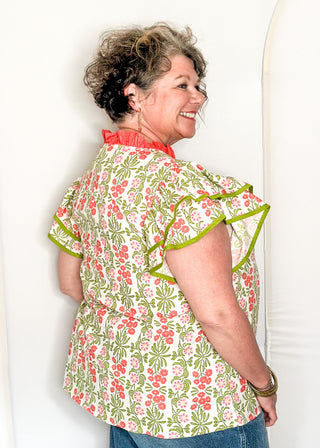 Floral print top with decorative neckline and short ruffle sleeves