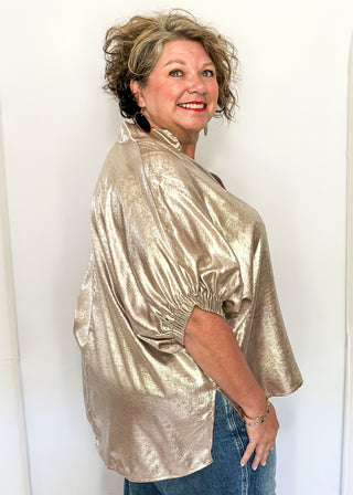 Shimmer Champagne V-neck blouse with relaxed elastic short sleeves and a split hem at waist. 