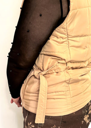 Beige puffer zip up vest with sides that tie and pockets