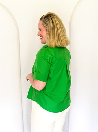 Collared green blouse with detailed gold snaps. short sleeve