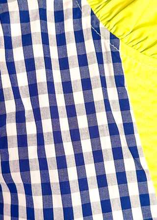 close up of women’s gingham blouse with decorative buttons and statement neckline detail.