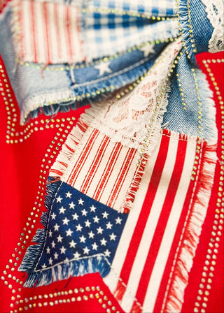 close up of red short sleeve tee with Americana quilted bow graphic and rhinestone detail.