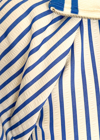 Women’s blue striped short sleeve 1/4 zip top with lightweight fabric, stripe elastic sleeve and collar detail.