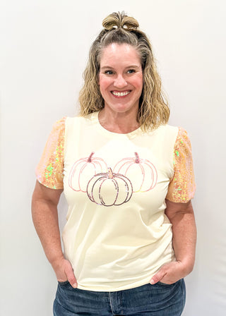 Ivory short sleeve top with sequin sleeves.  3 sequin pumpkins on the front. 