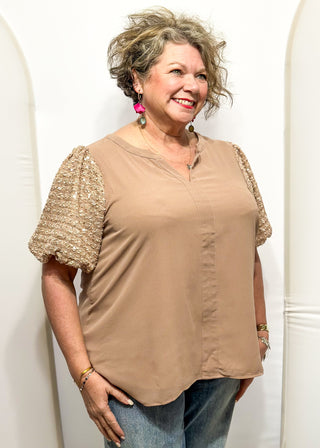 Rose-colored top featuring sparkly sequin puff sleeves and a relaxed, flowy body.