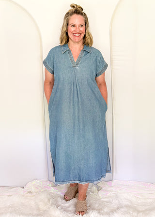 Woman wearing a blue dress standing against a white background