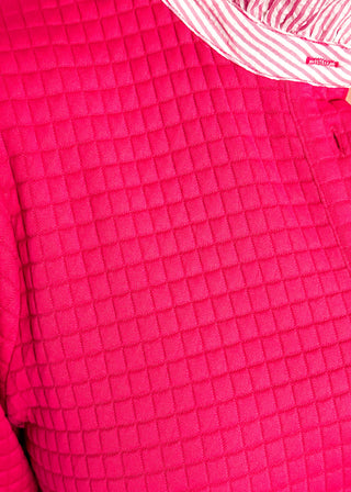 Hot pink quilted dress with striped collar and three-quarter sleeves.
