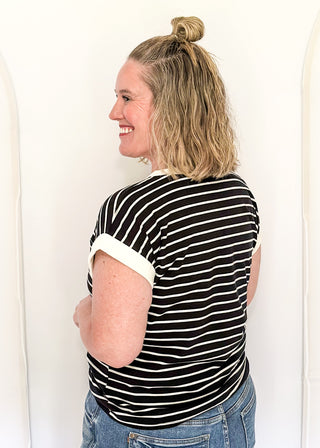 wide striped top with cuffed sleeves, and white banded rounded neckline.
