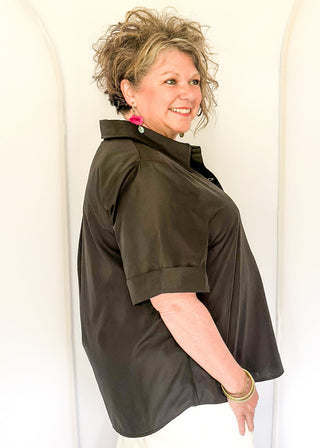 Collared black blouse with detailed gold snaps. short sleeve