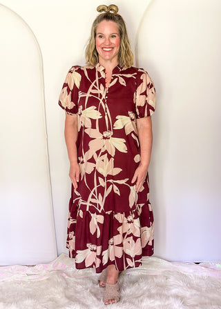 woman wearing tiered midi dress in Burgundy abstract floral print.