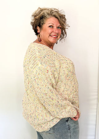 multi fleck of color on this cream button up cardigan.  Oversized fit with two large pockets on the front. 