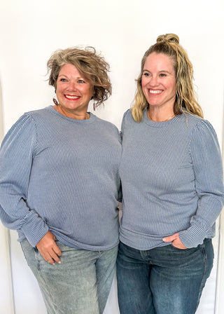 long sleeve ribbed top with cuff sleeve and small puff detail in shoulder. crew neck. 