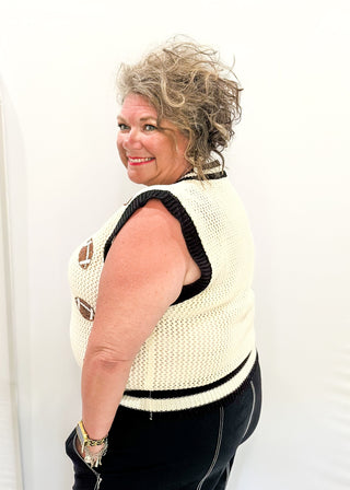Cream open weave sleeveless sweater - need to wear something underneath - football sequin patches and black and cream varsity style trim around v-neck and bottom banding.