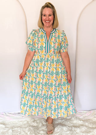 Floral midi dress with contrast neckline, short puff sleeves, and tiered skirt