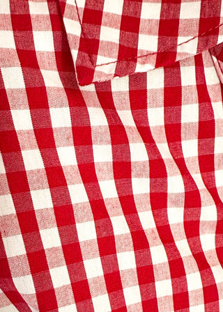 Close up of gingham blouse with split neckline, collar, and 3/4 sleeves.