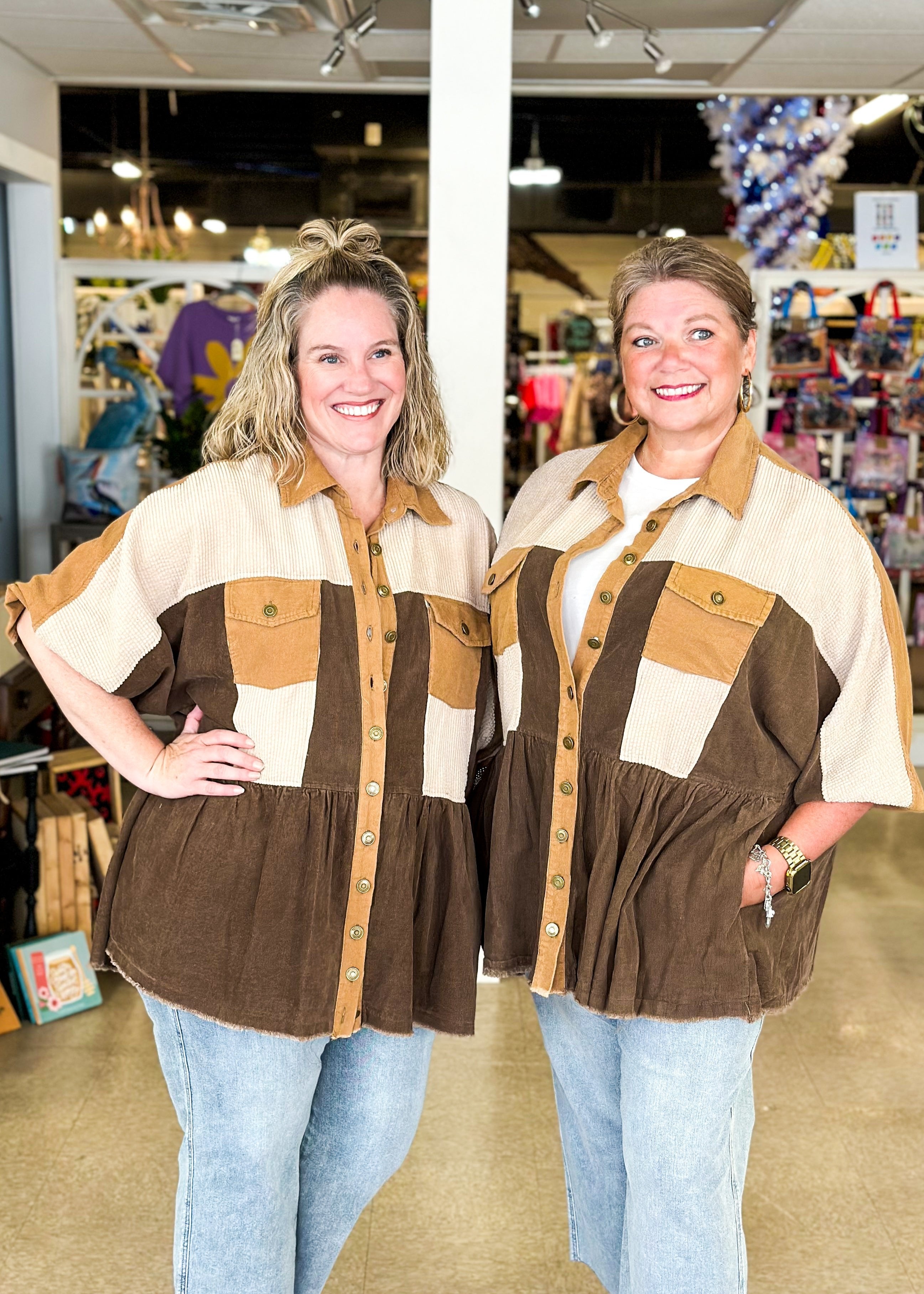 corduroy shacket with functioning buttons down the front and collar, one tier at the bottom, good coverage, shades of brown, sleeve hits at elbow, pockets