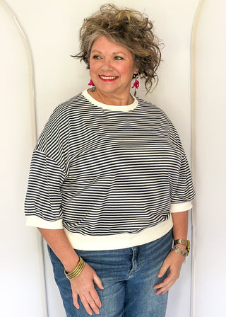 Striped knit dolman top with crew neckline and ribbed trim in navy.