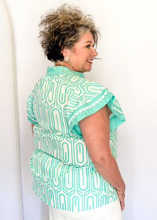 Patterned short-sleeve top in mint with contrast trim with scallops, v-neckline.