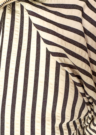 Short sleeve black and off white vertical stripes, zip front collar.  Collar and sleeve has contrast trim with bold stripe