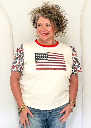 Sequin Flag with red and blue sequin star sleeves and red contrast banding on collar. 