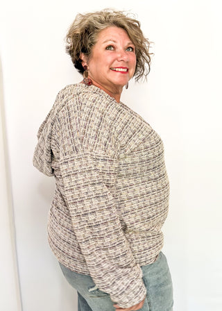 tweed hooded long sleeve top with pockets.  Colors of purple, cream, gray