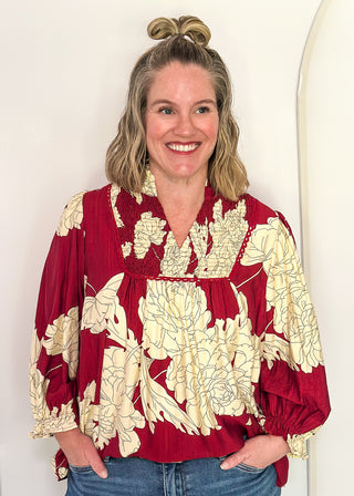 woman in longsleeve burgundy floral top