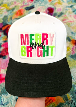 Trucker hat with 'Merry and Bright' text on a colorful background