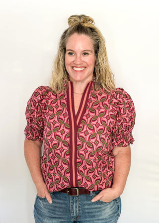 Bubble sleeve V-neck short sleeve top in wine with dark wine and olive design. Piping detail down the front in deep wine and terracotta. 