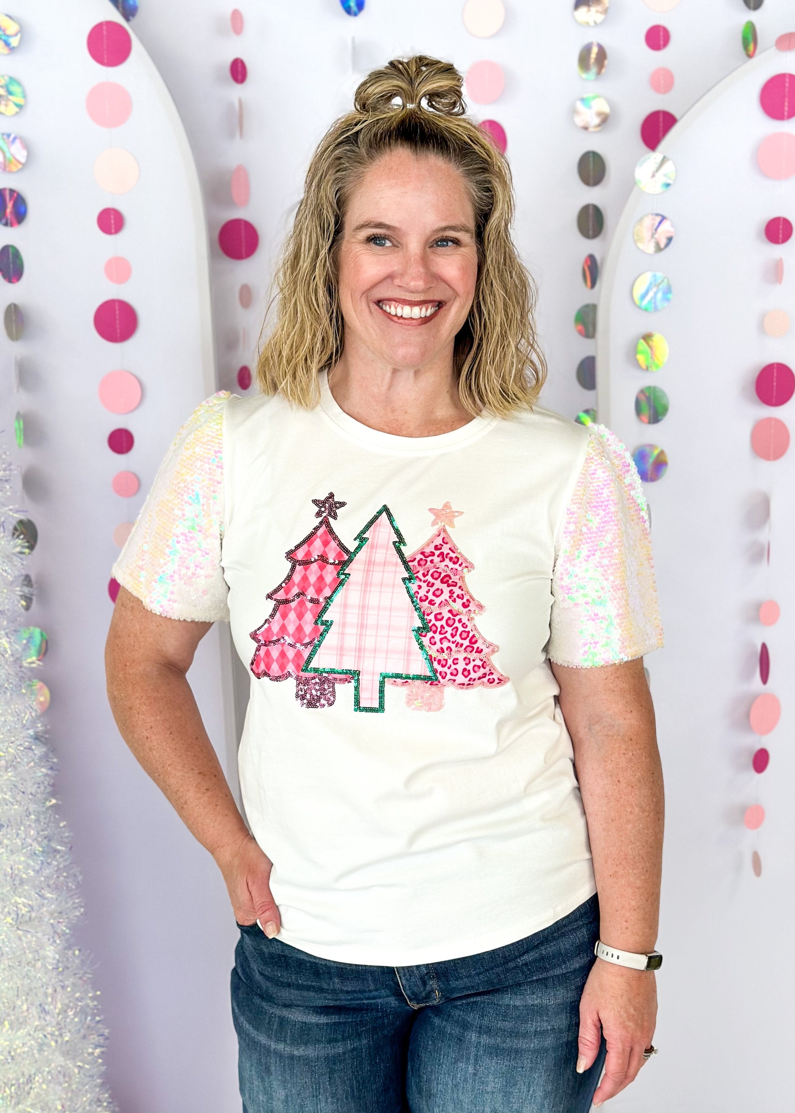 white short sleeve top with iridescent sequin sleeves, round neck, sparkly trio of trees patch on the front