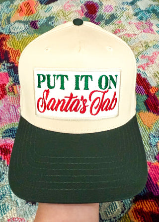 Cap with 'Put It On Santa's Lab' text on a colorful patterned background