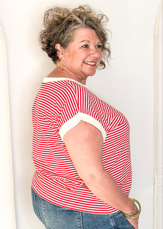 Red and white striped short sleeve top with white banding on sleeve and collar. 