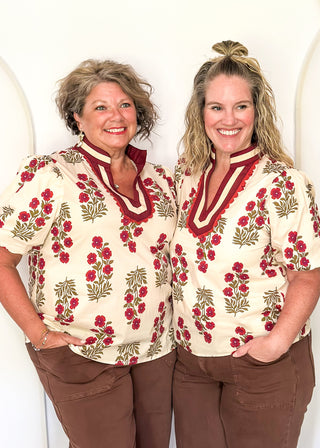 Short sleeve top in ecru with wine floral bundles with olive green leaves.  Collar contrast detail in wine and beige with small scallop trim.