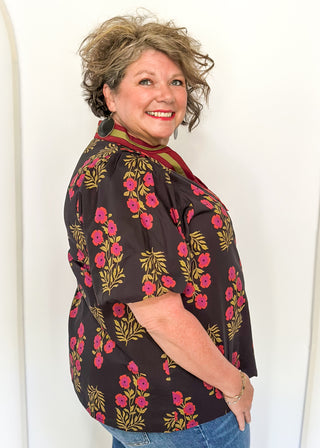 floral black -neck with ribbons of green and wine around v-neck and same colored floral pattern on  top - short sleeve