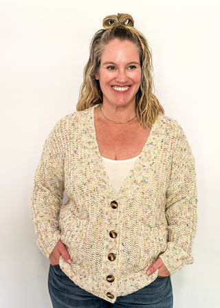 multi fleck of color on this cream button up cardigan.  Oversized fit with two large pockets on the front. 