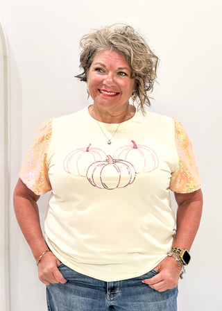 Ivory short sleeve top with sequin sleeves.  3 sequin pumpkins on the front. 