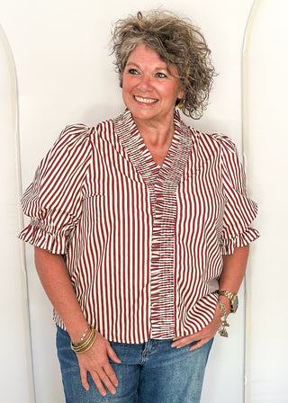woman wearing striped short sleeve top and jeans. 