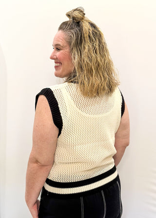 Cream open weave sleeveless sweater - need to wear something underneath - football sequin patches and black and cream varsity style trim around v-neck and bottom banding.