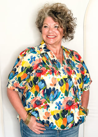 Multicolor floral blouse with smocked detail and short sleeves