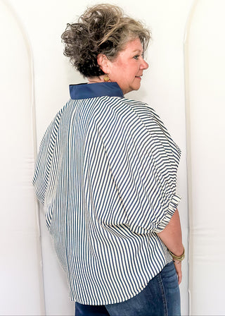 Model wearing an indigo-colored Entro dolman striped top with contrast trim, styled in a relaxed, casual fit.