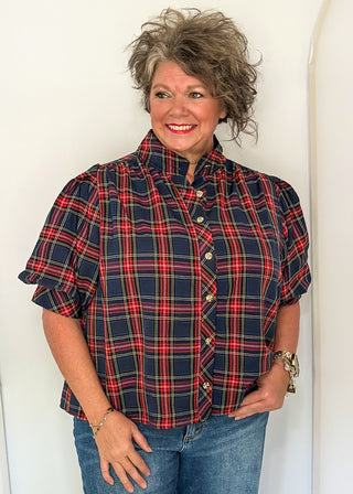 woman wearing a short sleeve button up top in Navy/Red plaid