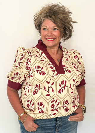 Neutral blouse featuring garnet florals with geometric hexagon pattern.