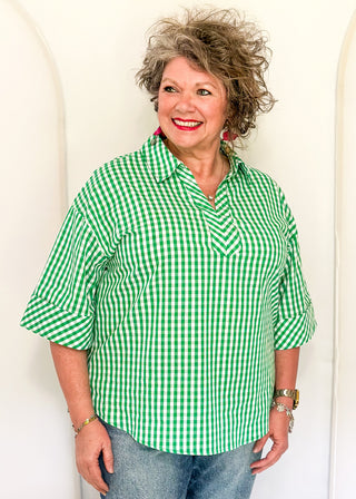 Gingham blouse with split neckline, collar, and 3/4 sleeves.