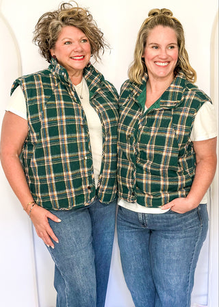 Green plaid puffer vest with snap front and side pockets.