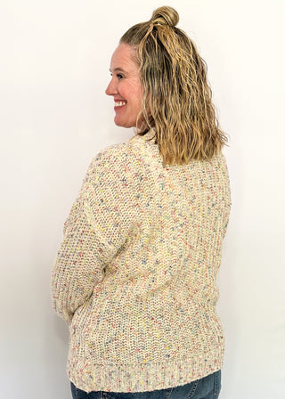 multi fleck of color on this cream button up cardigan.  Oversized fit with two large pockets on the front. 