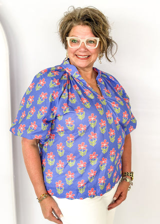 periwinkle floral top with puff short sleeves and v-neck