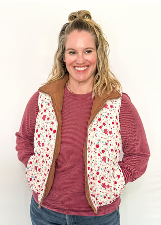 Reversible puffer vest with red and pink floral on one side, brown corduroy on the other.  Pockets on both sides, collared with zipper closure.