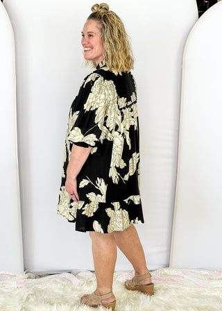 Black knee length dress with large white florals. 3/4 length flowy sleeve. Black scallop detail on chest. Lined 