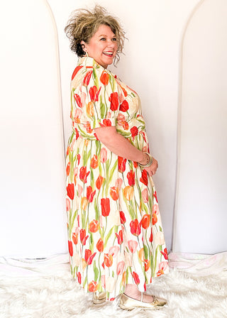 Tulip print midi dress with short sleeves, smocked waist, pockets, and lined fabric