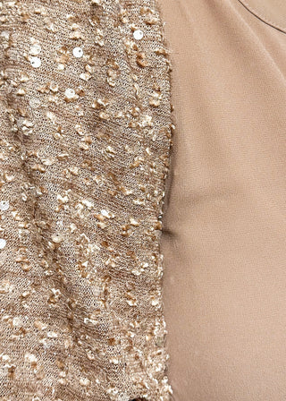 Rose-colored top featuring sparkly sequin puff sleeves and a relaxed, flowy body.