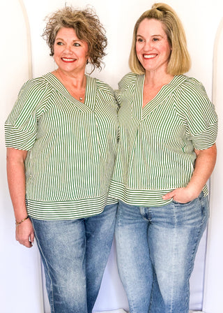 Green striped blouse with lightweight seersucker fabric, short sleeves, and relaxed shape.